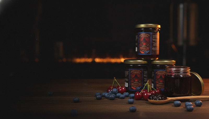Rumaretto rum jam jars with fresh cherries and blueberries
