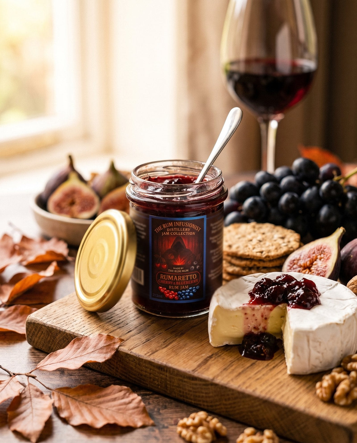 Rumaretto Cherry & Blueberry Rum Jam on an autumn cheeseboard with brie, figs and grapes
