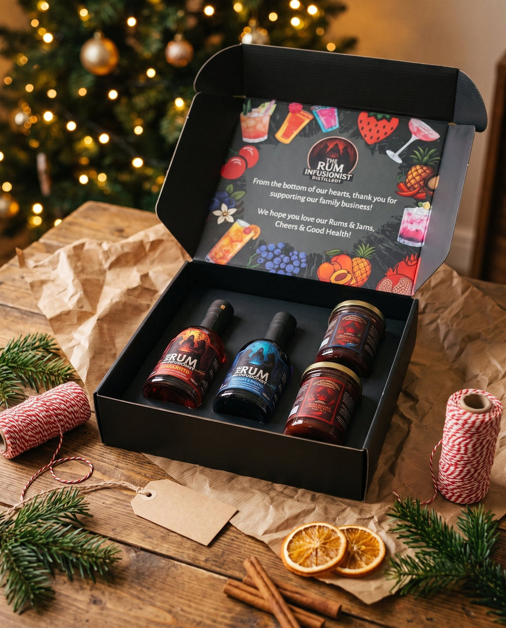 Rum and jam gift set in its presentation box surrounded by Christmas wrapping